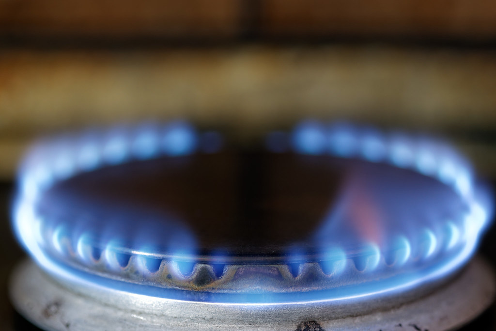 The same blue flame burns either way — the difference is the ledger behind it. Photo: Ervins Strauhmanis, CC BY 2.0